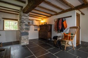 a room with a stone fireplace and a chair at Panoramic Views & Spacious Living by LetMeStay in Grasmere