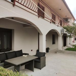 a patio with a table and chairs on a building at Apartman AMELIE A4 in Pula +46 photos