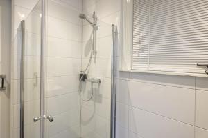 
a bathroom with a shower stall and a shower curtain at Suite aan de A in Groningen
