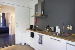 a kitchen with a sink and a counter top at Suite aan de A in Groningen