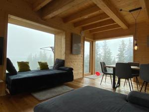 a living room with a couch and a table at Chalet Theresa in Bad Sankt Leonhard im Lavanttal