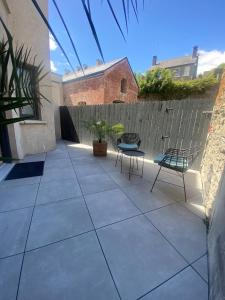 a patio with two chairs and a fence at The Glen Quarter in Kinsale