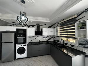 a kitchen with a washing machine and a washer and dryer at Villa Baya in El Haouaria