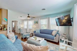 a living room with a blue couch and a tv at Gone Intracoastal in Ocean Isle Beach