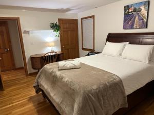 a bedroom with a bed and a desk with a lamp at Boston Single Family House - 19' Train to Back Bay in Boston