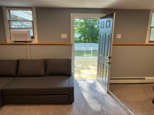 a living room with a couch and a sliding door at Boston Single Family House - 19' Train to Back Bay in Boston