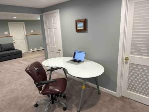 a room with a table with a laptop on it at Boston Single Family House - 19' Train to Back Bay in Boston