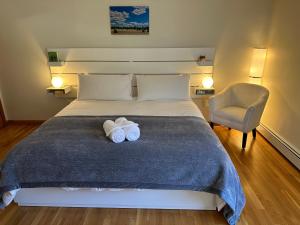 a bedroom with a bed with two towels on it at Boston Single Family House - 19' Train to Back Bay in Boston