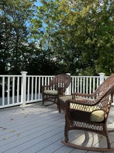 two wicker benches sitting on a wooden deck at Boston Single Family House - 19' Train to Back Bay in Boston