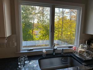 a kitchen sink with a large window above it at Boston Single Family House - 19' Train to Back Bay in Boston