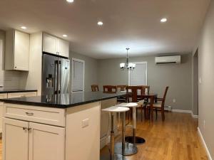 a kitchen and dining room with a table and chairs at Boston Single Family House - 19' Train to Back Bay in Boston