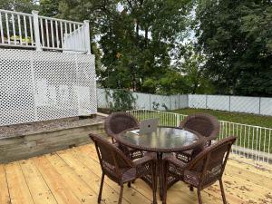 a table and chairs on a deck with a laptop on it at Boston Single Family House - 19' Train to Back Bay in Boston