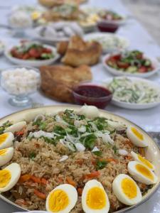 a plate of rice and eggs on a table at Dan guest house in Pokrovka