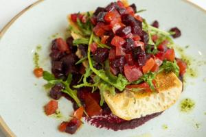 a plate of food with a salad and a sandwich at Aloft London Excel in London