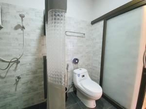 a bathroom with a toilet and a shower at Layo Homestay in Ban Pha Mi