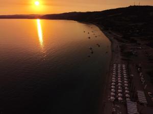 an aerial view of a beach at sunset at By the Sea in Xiropótamon