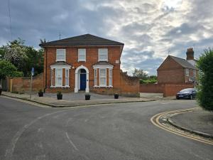 a brick house with a blue door on a street at PRIVATE ROOM In TOWN CENTRE FREE PARKING WI FI AND PATIO WITH AA STAY LTD in Buckinghamshire