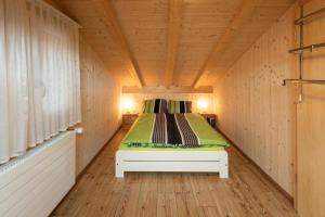 a room with a bed in a wooden house at Ferienhaus Schwand in Giswil