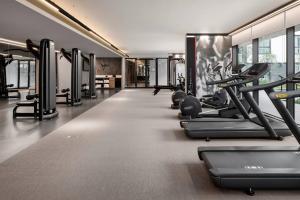 a gym with treadmills and elliptical machines at Johannesburg Marriott Hotel Melrose Arch in Johannesburg