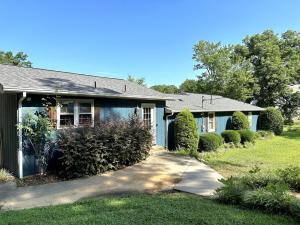 a blue house with a driveway in front of it at Lady of the Lake in Chapin