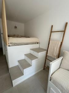 a bedroom with stairs leading up to a bunk bed at Chez Timmaflo in Fréjus +13 photos