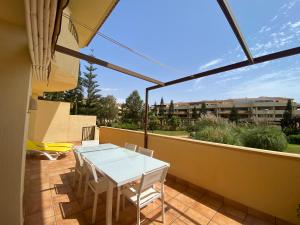 eine Terrasse mit einem weißen Tisch und Stühlen auf dem Balkon in der Unterkunft Victor Villa Romana in Roquetas de Mar