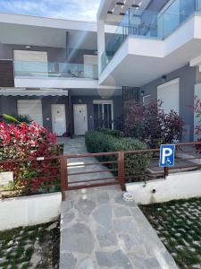 a house with a fence and a parking sign in front of it at Perla 2 Paralia Ofriniou in Ofrínion