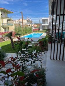 a swimming pool in a yard next to a building at Perla 2 Paralia Ofriniou in Ofrínion