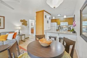 a kitchen and living room with a table and chairs at Kahaki Hale in Kapaa