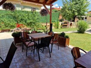 a patio with a table and chairs under a roof at Konak -Guest house -Ramonda Serbika in Niš