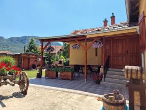 a patio of a house with a table and chairs at Konak -Guest house -Ramonda Serbika in Niš