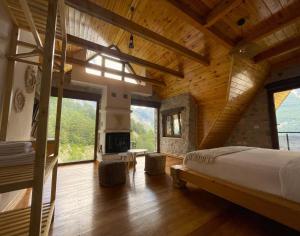 a bedroom with a large bed and a fireplace at Valter & Drita's Guesthouse in Theth