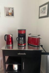 two red appliances sitting on top of a table at Ferienwohnung Biel in Bodenwerder