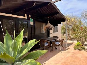 a patio with a table and chairs and a house at Casa Clot III- Formentera in Illes Balears