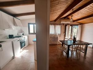 a kitchen and dining room with a table and chairs at Casa Clot III- Formentera in Illes Balears