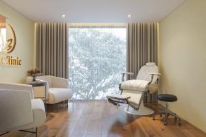 een therapiekamer met 2 stoelen en een raam bij Ja Cosmo Hotel and Spa in Hanoi
