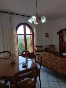 a living room with a table and a couch at M&M Home in Trappitello +8 photos