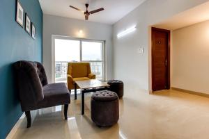 a living room with a chair and a table at OYO SilverKey Oyo Silverkey ,near RTO office kondapur in Kondapur