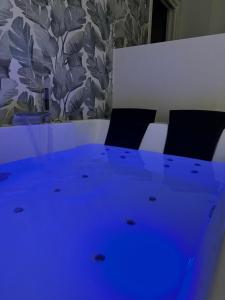 a meeting room with a blue table and chairs at Luxury apartment - SUITE CAVOUR in Bari