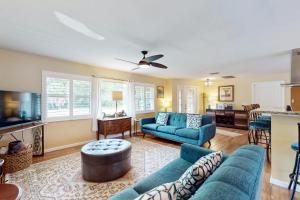 a living room with blue couches and a table at Mermaid Shores in Sarasota