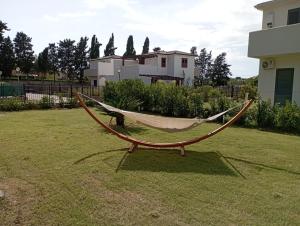 a hammock sitting in the middle of a yard at Villa Charme & Relax in Campofelice di Roccella +30 photos
