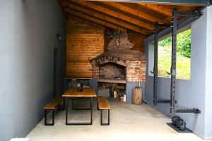 a room with a table and a brick oven at Casa Vinea in Karlovac