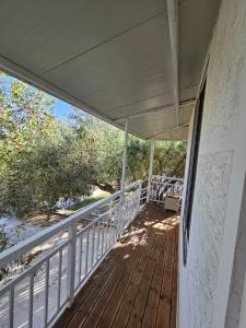 a porch of a house with awning and trees at SEA bed and restaurant 2 in Borsh
