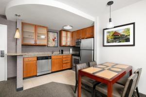 a kitchen with a table and a dining room at Residence Inn Concord in Concord