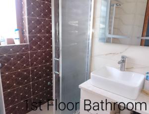 a bathroom with a sink and a shower at Leos Villa in Tragjas