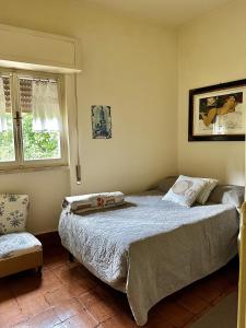 a bedroom with a bed and a chair at Villa bianca in Piediluco +11 photos