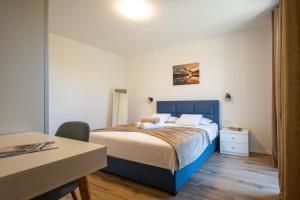 a bedroom with a bed with a blue headboard at Apartment Iva in Vrana