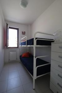 a bedroom with two bunk beds and a window at Trilocale a 350 metri dal mare in Marcelli