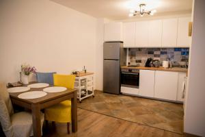 a kitchen with a table and a refrigerator at VARNA SEA VIEW Apartment in Varna City