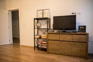 a living room with a television on a wooden dresser at VARNA SEA VIEW Apartment in Varna City